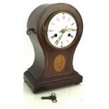 An inlaid mahogany clock, the white enamel dial with Roman numerals, on bun feet,
