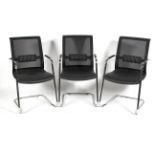 A set of three chrome and faux leather dining chairs with mesh backs in the Pieff style,