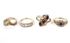 Four 9ct gold dress rings, one set with garnets and one in a rope wishbone, setting total weight 15.