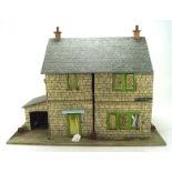 A vintage dolls house named 'Thomson St', opening to reveal a selection of related furniture,