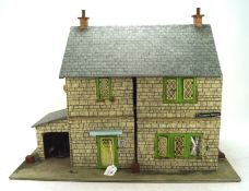 A vintage dolls house named 'Thomson St', opening to reveal a selection of related furniture,