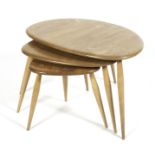 An Ercol blonde elm pebble nest of three tables,