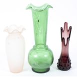 Three 20th century glass vases, in green, aubergine and pale pink, all with fluted rims,