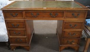 A mid-20th century leather-topped desk, with central frieze drawer,