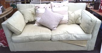 A contemporary two seater pale green sofa,