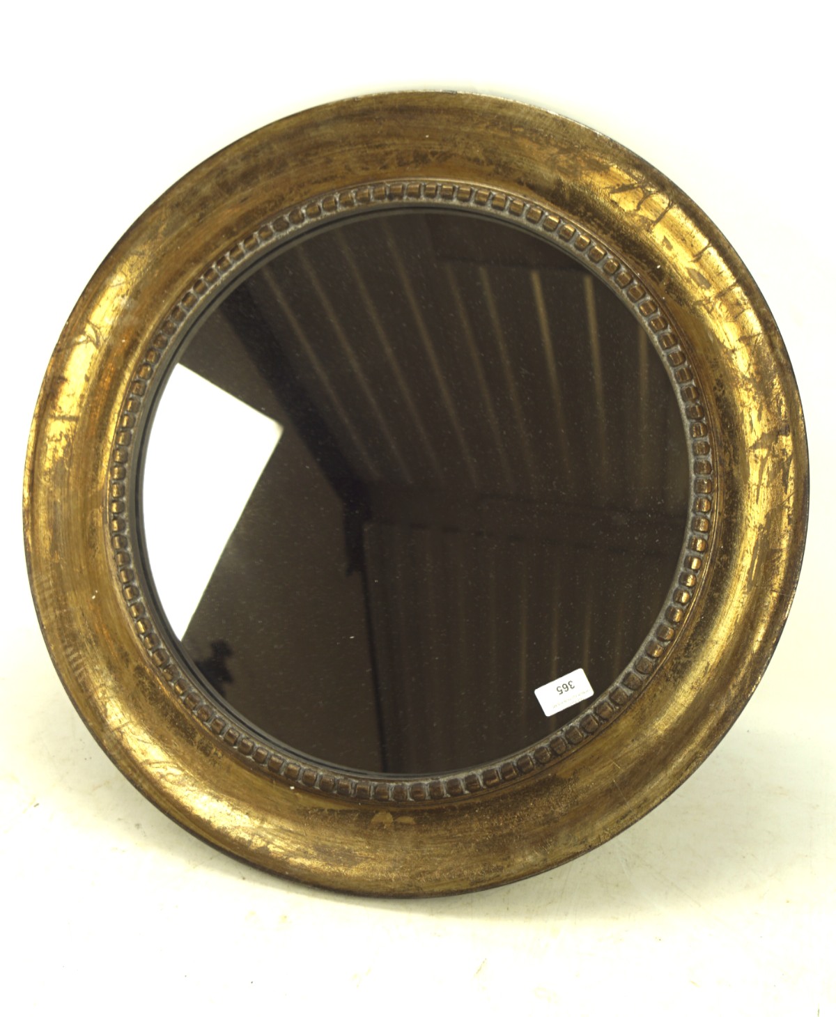 A contemporary giltwood circular wall mirror, with dentil border, 60 cm diam.