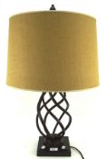 A contemporary table lamp, the metal frame modelled with a spiral effect on a square base,