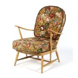 An Ercol blonde spindle back open armchair, with removable cushions,