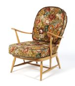 An Ercol blonde spindle back open armchair, with removable cushions,