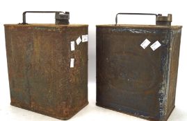 Two vintage petrol cans, one being Esso, the other Pratts,