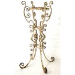 A cast metal jardiniere stand, decorated with scrolls and flowers, painted white,