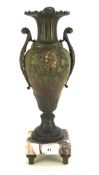 An early 20th Century Continental patinated bronze vase with cast leaf scroll handles and Bacchus