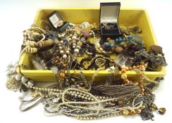 An assortment of vintage costume jewellery, including silver pendants and crosses,