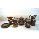 A collection of lustreware and other ceramics, comprising a teapot and three jugs,