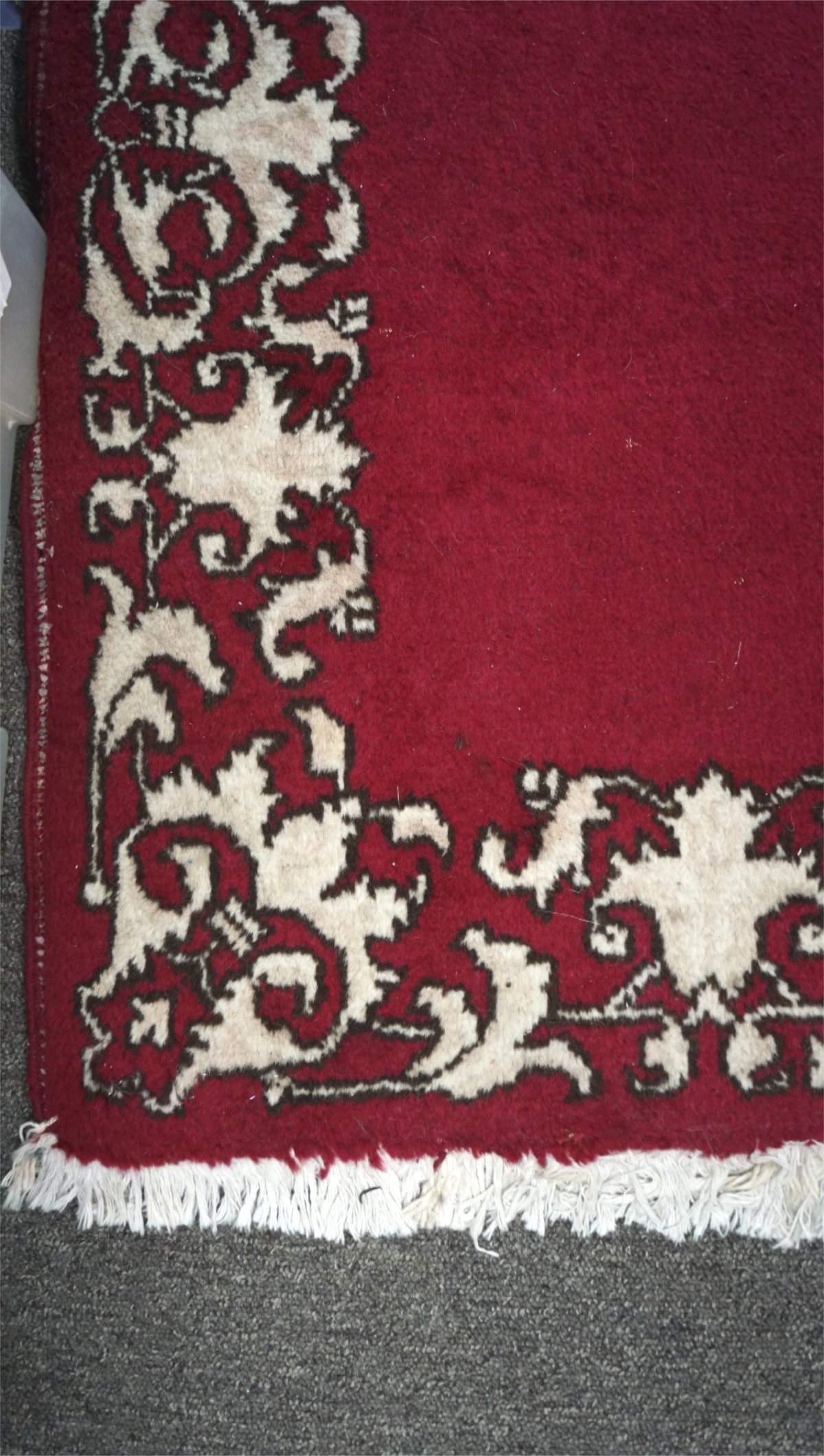 A Tabriz runner, with a cream border on a red ground, tassels to either end, - Image 2 of 2