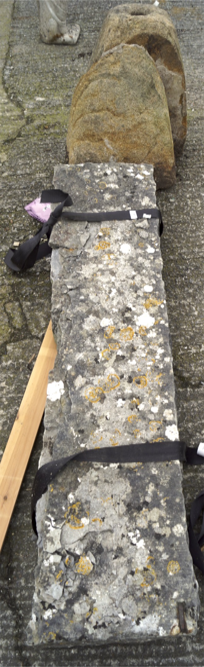 A large weathered slate slab measuring circa 165 in length, and a natural saddle stone base,