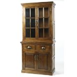 A 20th century oak glazed dresser, the two glazed doors opening to reveal three tiers,