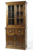 A 20th century oak glazed dresser, the two glazed doors opening to reveal three tiers,