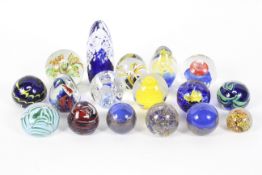 Seventeen paperweights, with inclusions in blue and yellow,