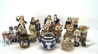 An assortment of Staffordshire pottery figures and other items, late 19th century/20th century,