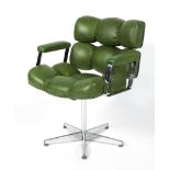 A designer faux green leather upholstered revolving elbow chair,