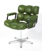 A designer faux green leather upholstered revolving elbow chair,