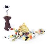 A vintage novelty Alessi corkscrew and an Italian ceramic figure of a clown,