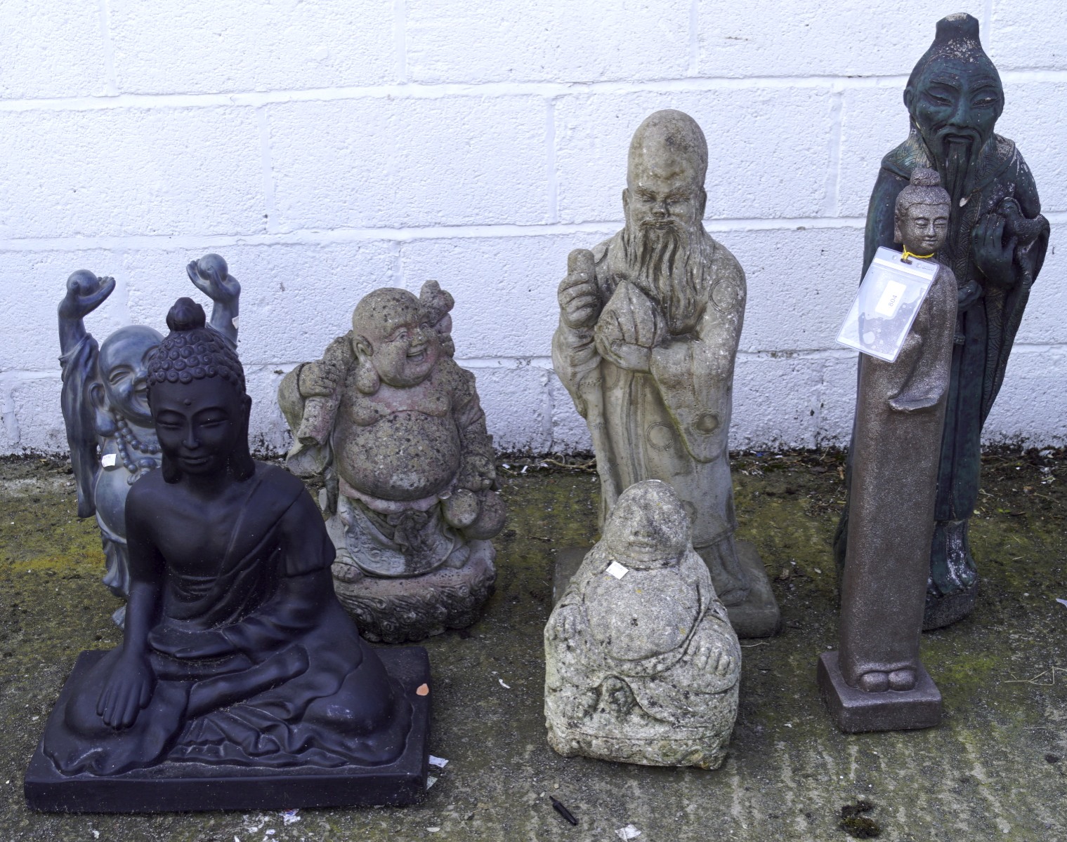 A collection of garden figures, including Buddhas, a Guanyin and immortals,