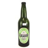 A large vintage empty green glass Heineken bottle, with cap,