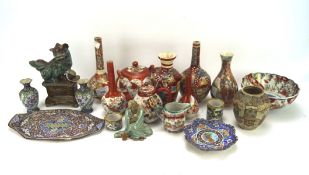 An assortment of Asian ceramics, including pairs of vases, a temple dog,