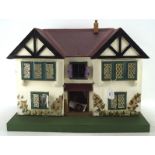 A vintage doll's house, mid-century, including some fittings and contents,