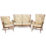 An Ercol spindle back upholstered three piece suite design 9142, 18/12/89,