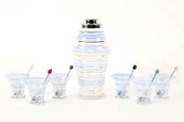 A 1950's cocktail shaker, six matching glasses and spoons, decorated with blue,