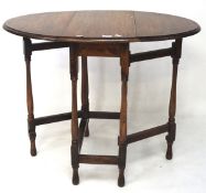 Early 20th century oak oval gateleg tea table, on turned baluster legs, L90.