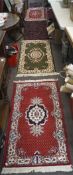 Five modern small rugs, including: an Indian wool example woven with red flowers on a blue ground,