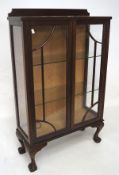 An early 20th century glazed mahogany display cabinet, the glazed astragal fronted double doors,