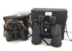 Two pairs of binoculars, a Super Zenith 20x50 and USSR 8x30 field glasses,