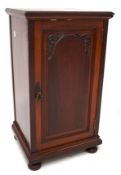 A 20th century hard wood pot cupboard, the single door opening to reveal two shelves,