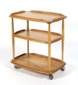 An Ercol push-pull blonde elm three tier tea trolley,