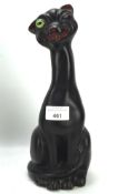 A ceramic figure of a black winking cat,