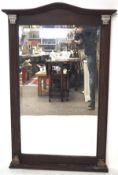 A 20th century bevelled edge wall mirror, the wooden frame with a shaped top and flanked by columns,