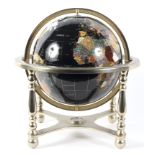 A table top globe mounted with semi-precious stones, within a brass frame,