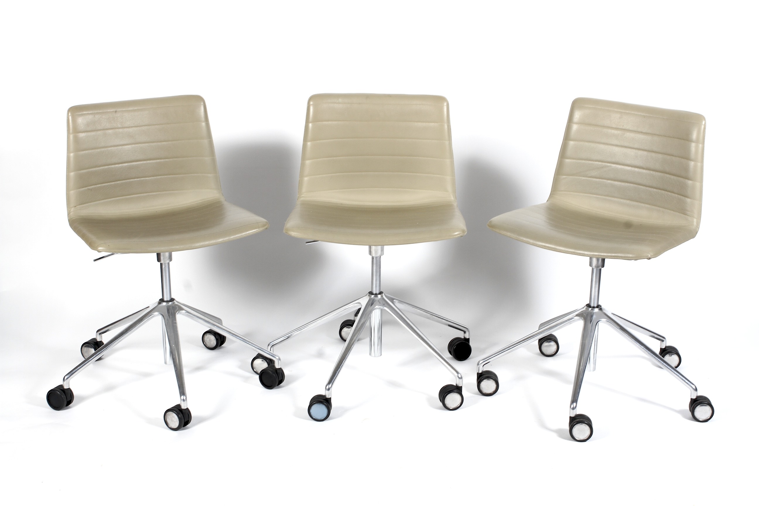 A set of three Andreu World (National Design Award Company 2007) faux leather swivel chairs,
