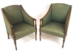 A pair of contemporary stained wooden green upholstered armchairs, raised upon carved,