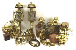 An assortment of metalware, including brass lanterns, microscope stands,