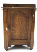 An Edwardian corner wall cabinet, featuring a panel front decorated with inlay,