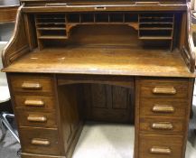 A mid-20th century oak roll top desk,