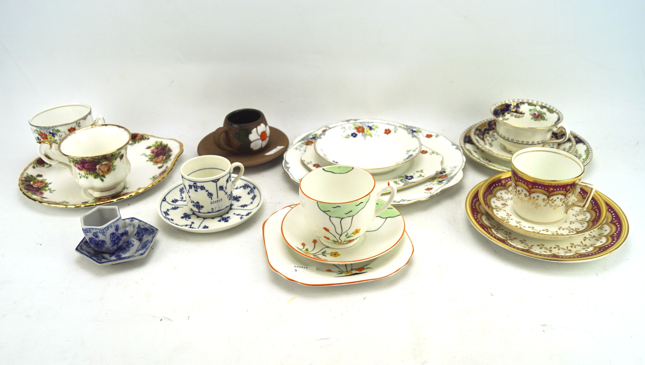 An assortment of trios and cups and saucers, including an Art Deco example,