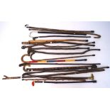 Five 20th century walking sticks, topped with metal handles modelled as animals and figures,