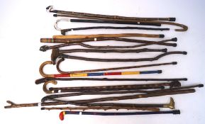 Five 20th century walking sticks, topped with metal handles modelled as animals and figures,